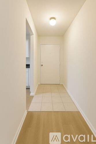 A long hallway with a door at the end.