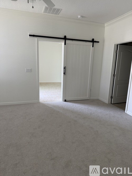A room with a sliding door and carpeted floor.