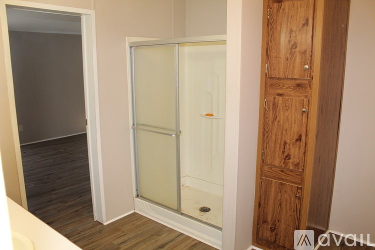 A room with a white door and a wooden door.