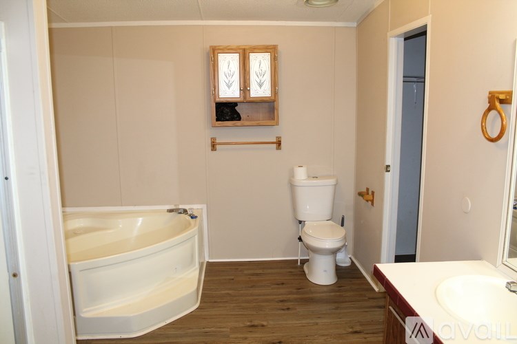 A white bathroom with a tub, toilet and sink.