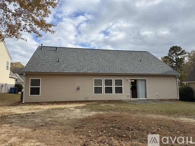A house with a grey roof and a white door is shown.