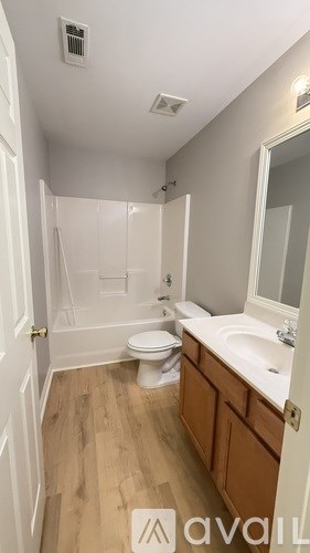 A bathroom with a toilet, sink, and shower.