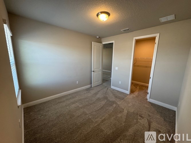 A room with a carpeted floor and a ceiling light.