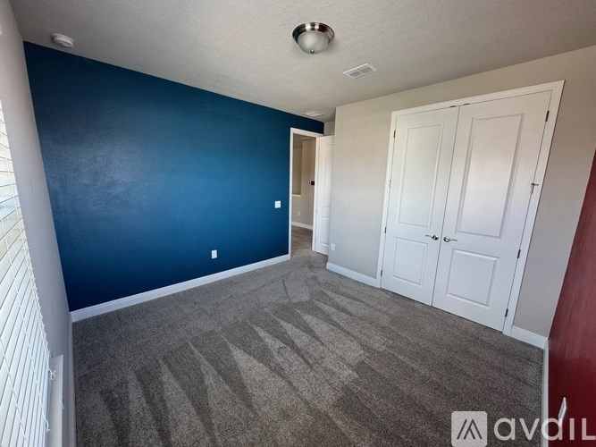 A room with blue walls and a carpeted floor.