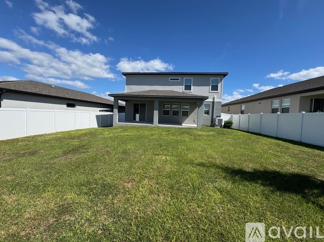 A house with a large lawn in front of it is for sale.