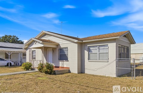 A house with a car parked in front of it.
