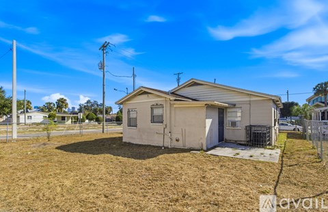A small house with a fence in front of it.