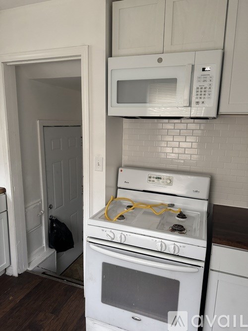 A white oven and microwave in a kitchen.