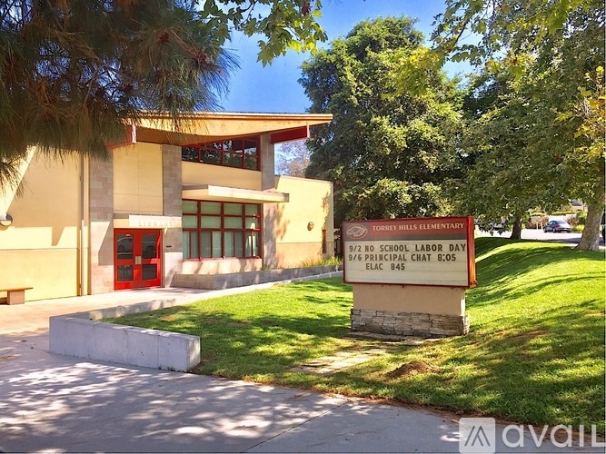 A sign in front of a building that says "9/20 SCHOOL LABOR DAY 9/6 PRINCIPAL CHAT 8:05 ELC 845".