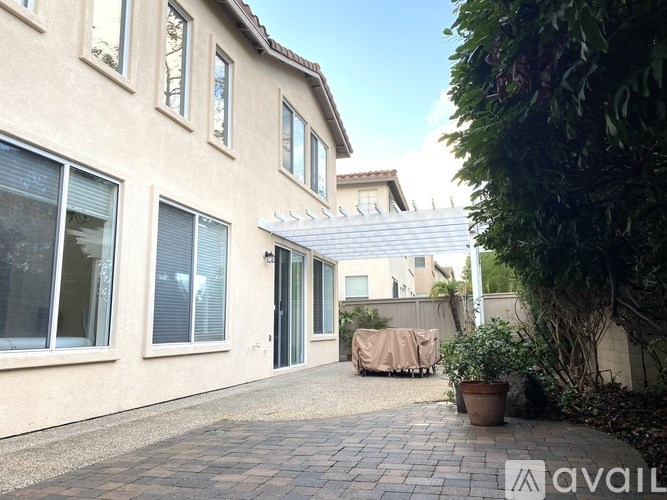 A house with a patio and a white awning.