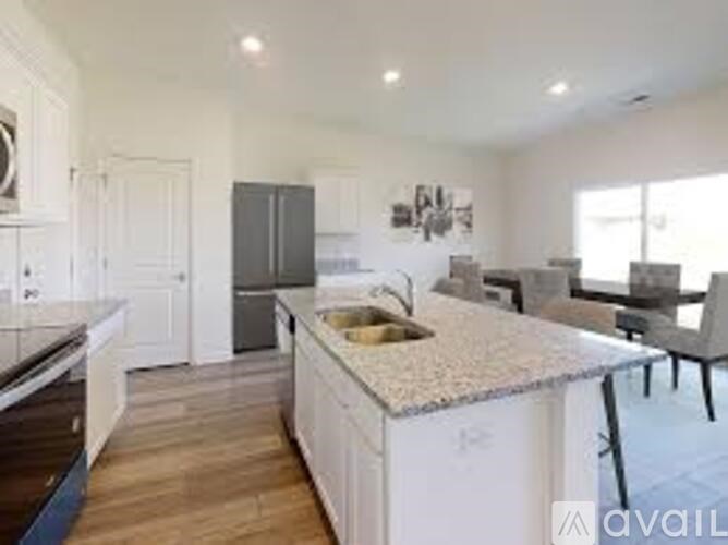 A kitchen with a granite countertop and a sink.