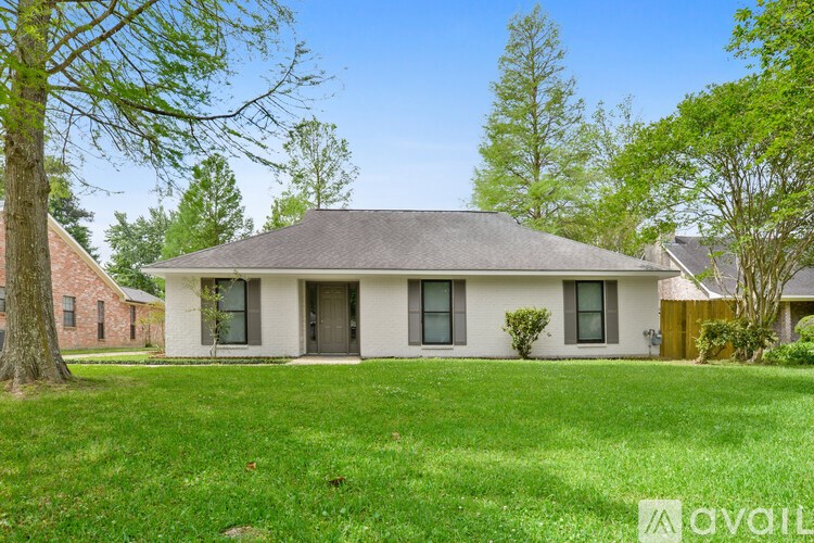 A house with a lawn in front of it is for sale.
