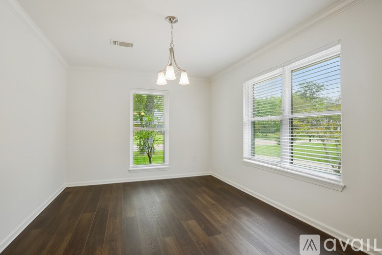 A room with a window showing a tree outside.