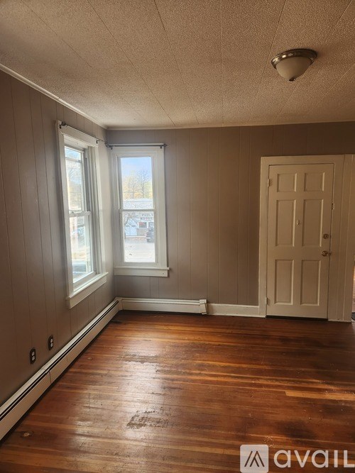 A room with wooden floors and a white door.