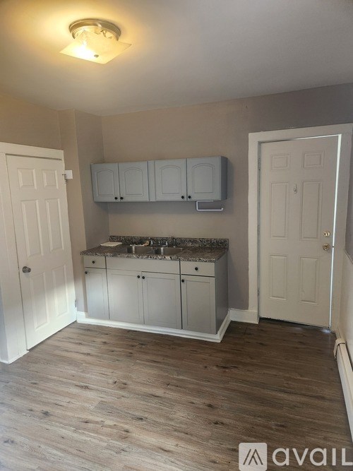 A kitchen area with a sink and cabinets.