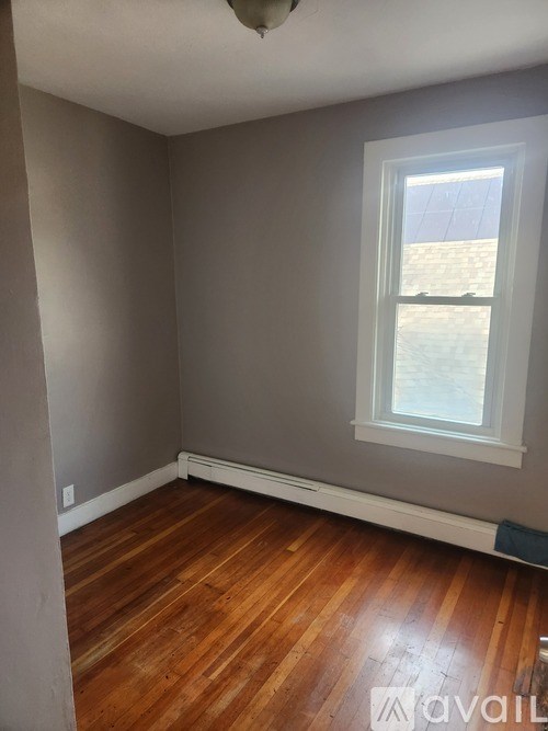 A room with wooden floors and a window.