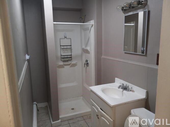 A bathroom with a sink, toilet, and shower.