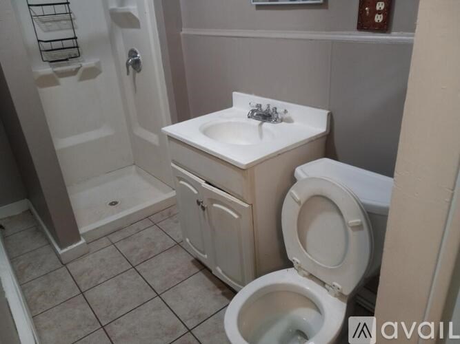 A white sink with a cabinet underneath it in a bathroom.