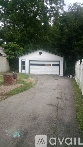 A white garage with a black logo on the front door.