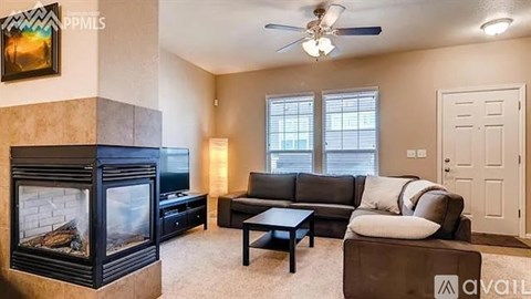 A living room with a fireplace and a couch.