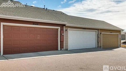 A two-car garage with a brown door is numbered 3549.