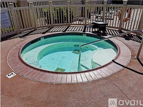 A round pool with a brown brick border.