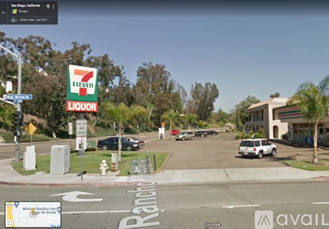 A 7-Eleven store is located on the corner of a street.