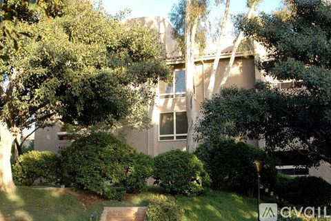 A house with a tree in front of it.