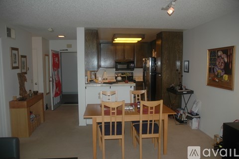 A kitchen with a table and chairs in the middle of the room.