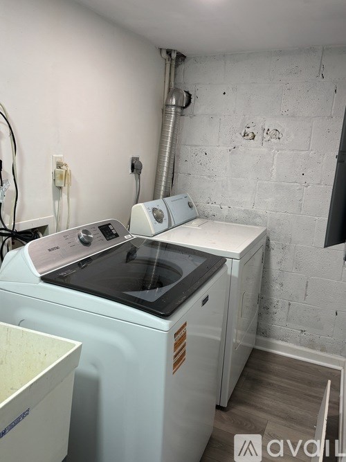 A washing machine and dryer in a small room.