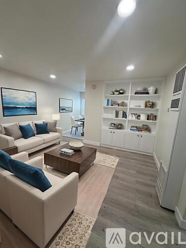 A living room with a white couch and a coffee table.