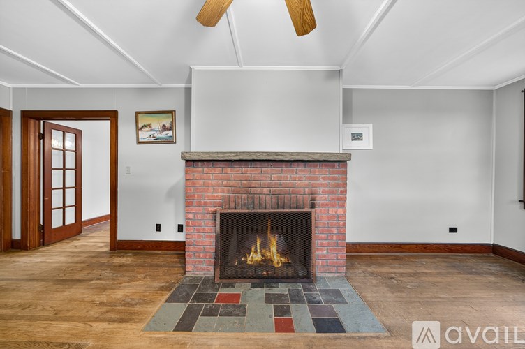 A room with a fireplace and a painting on the wall.