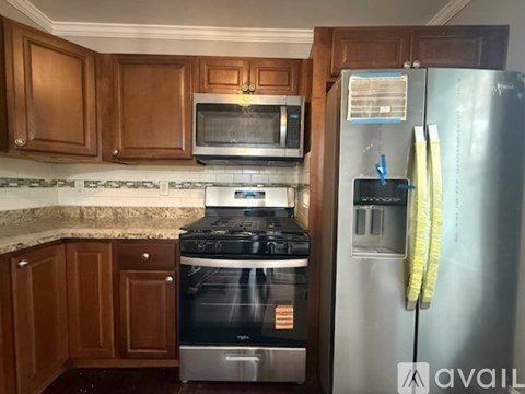 A kitchen with a stove, microwave, and refrigerator.