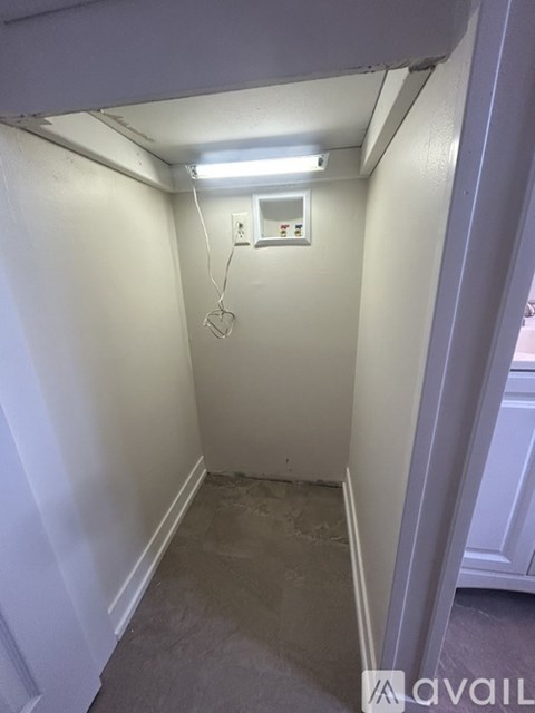 A small, empty room with a light on.