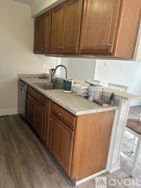 A kitchen with wooden cabinets and a marble countertop.
