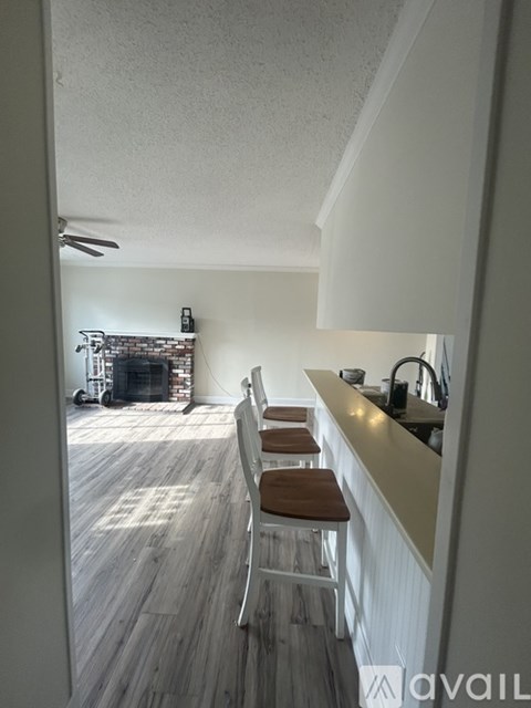 A kitchen with a bar stool and a counter.