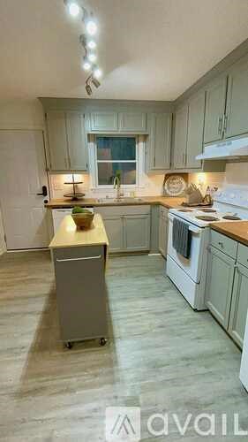 A kitchen with a refrigerator, a stove, and a dishwasher.