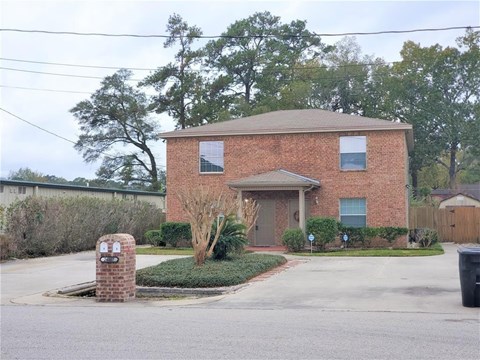 A house with a brick chimney in front of it.