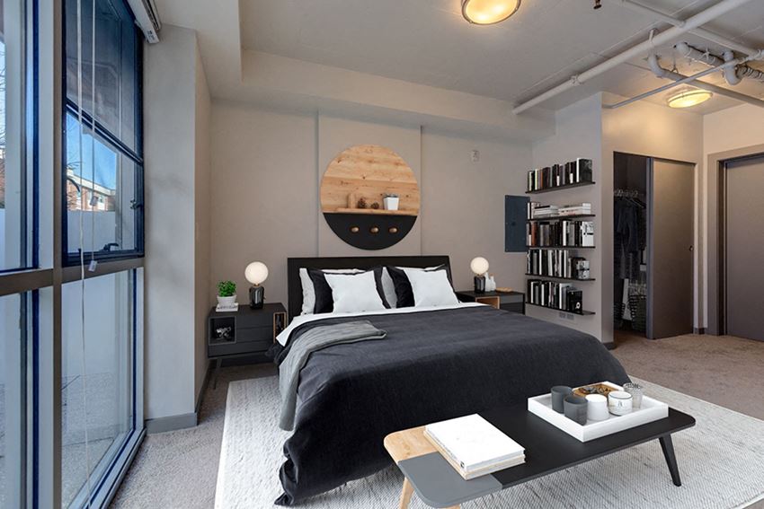 Model Apartment Bedroom with Bed, Bookcase, and Closet Storage