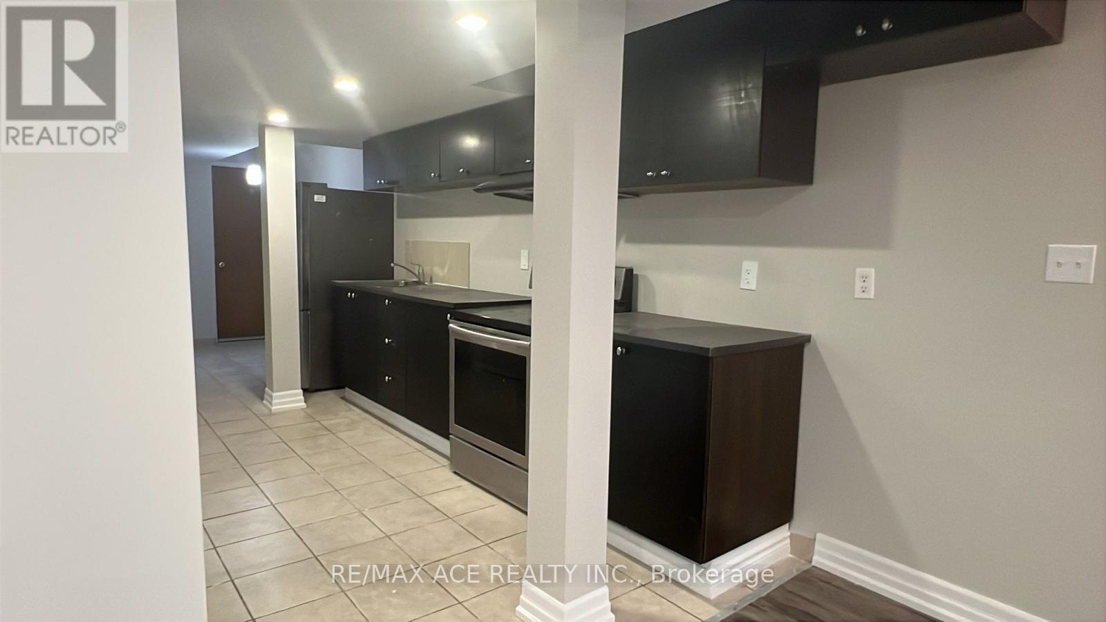 A kitchen with a black countertop and white walls.