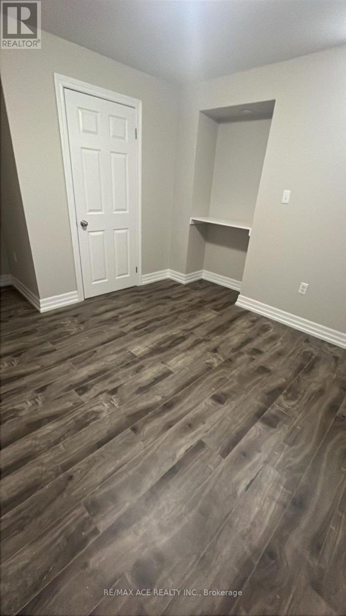 A room with a wooden floor and a white door.