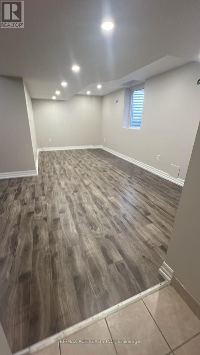 A room with a wood floor and a window.