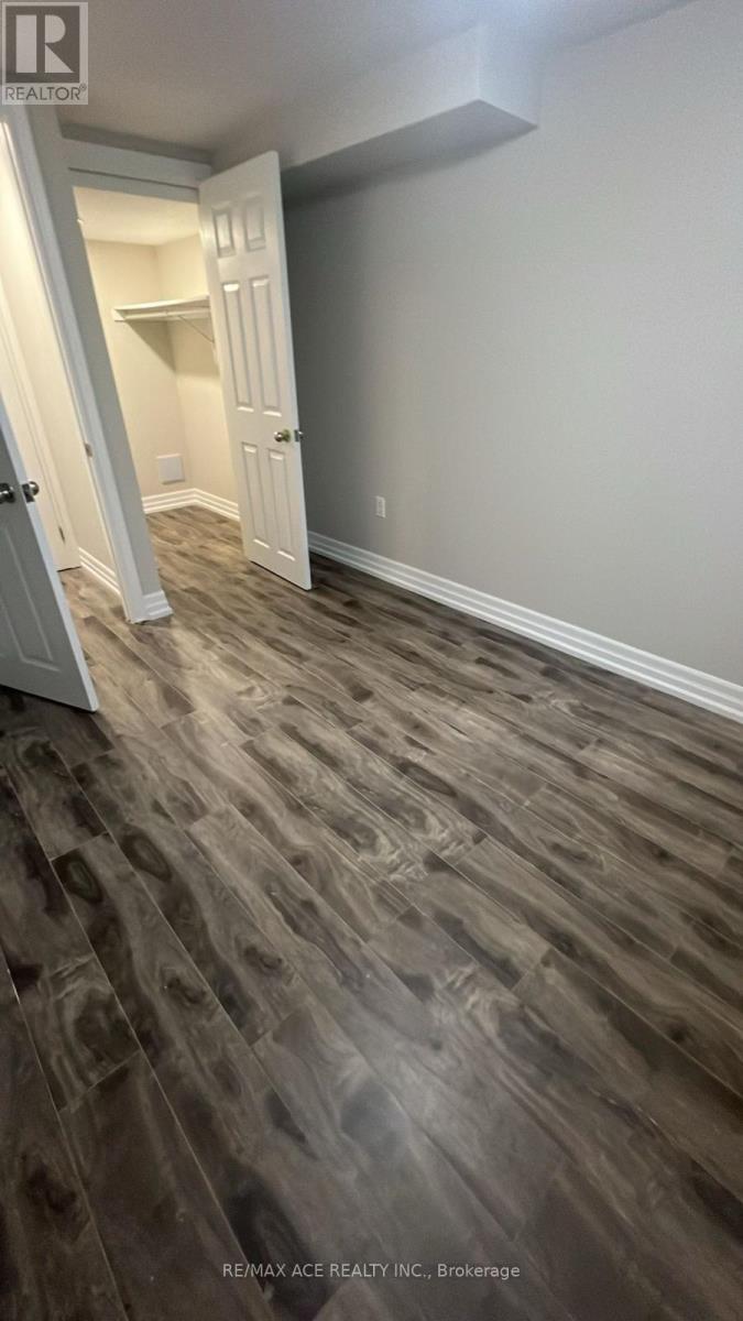 A hallway with wood flooring and white doors.