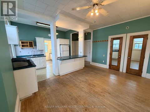 A kitchen with a black counter top and white cabinets.