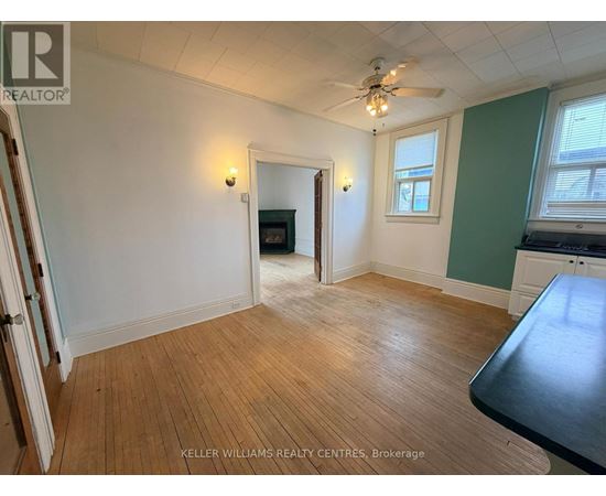 A room with a wooden floor and a ceiling fan.