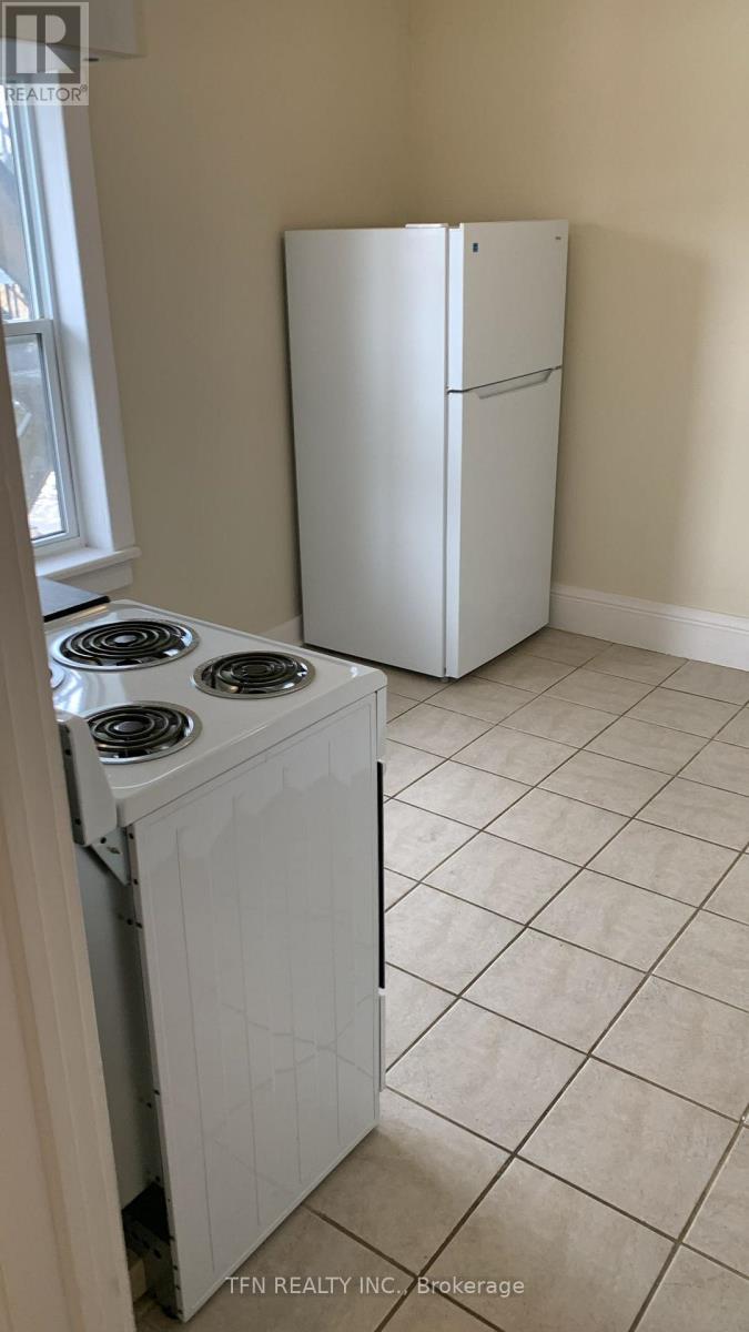 A white refrigerator and a white stove in a kitchen.