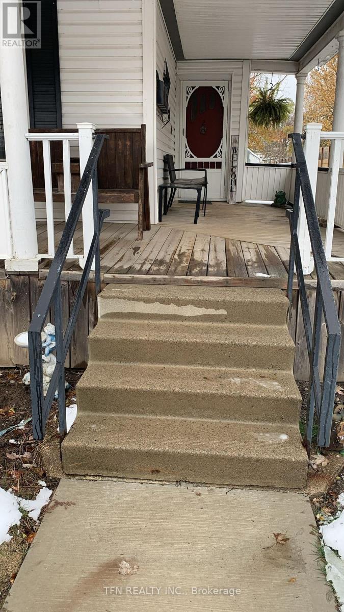 A set of stairs leading to a door with a red door.