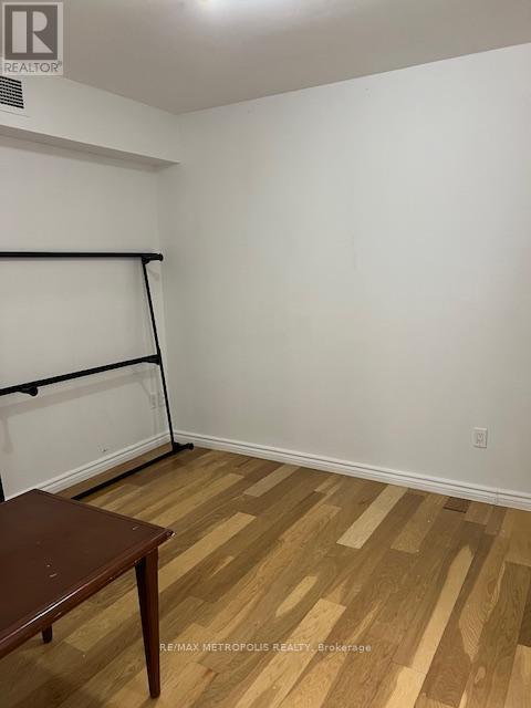 A room with a wooden floor and a table.