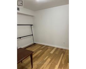 A room with a wooden floor and a table.