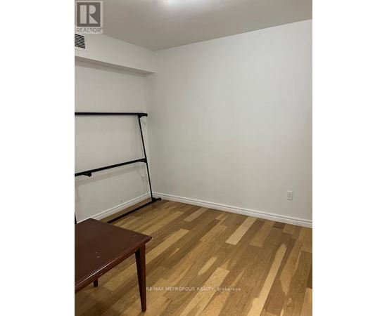 A room with a wooden floor and a table.